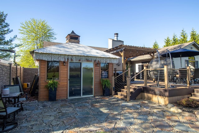 7042 Calkins Rd, Flint, MI 48532 - rear view of house featuring a patio area, fence, a pergola, a wooden deck, and a chimney