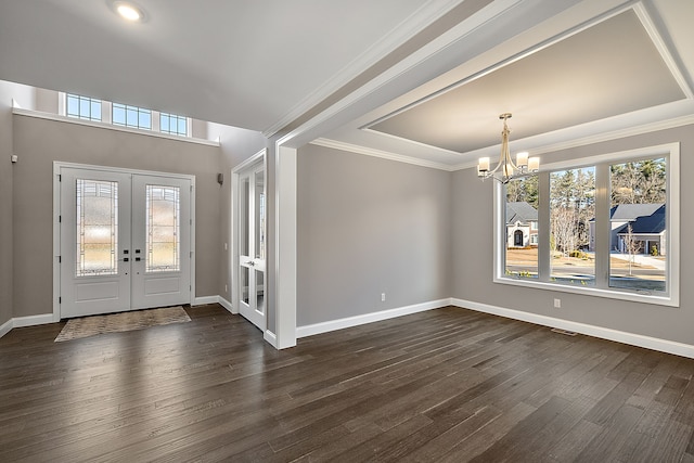 foyer with dark wood-type flooring, a healthy amount of sunlight, french doors, and an inviting chandelier