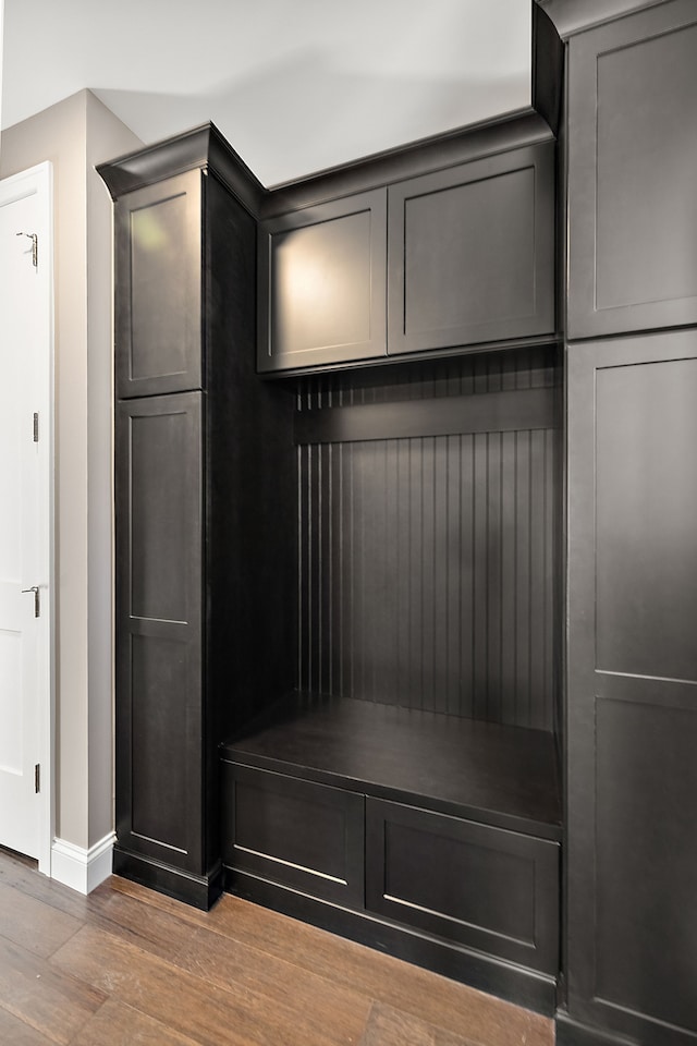 mudroom featuring baseboards and wood finished floors