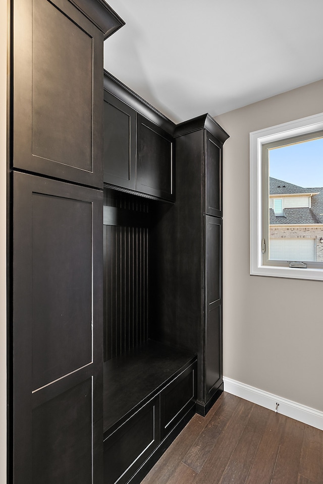 mudroom featuring dark wood-style floors and baseboards
