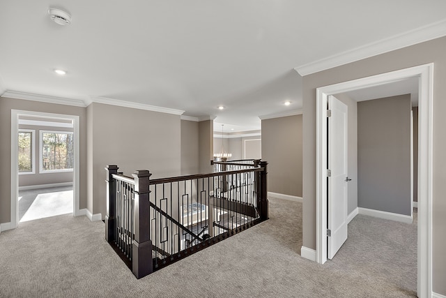 hallway featuring carpet flooring, an upstairs landing, baseboards, and a notable chandelier