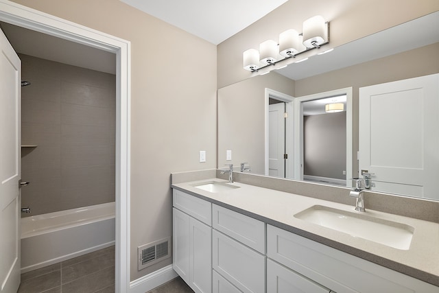 bathroom with visible vents, a sink, tile patterned floors, and double vanity