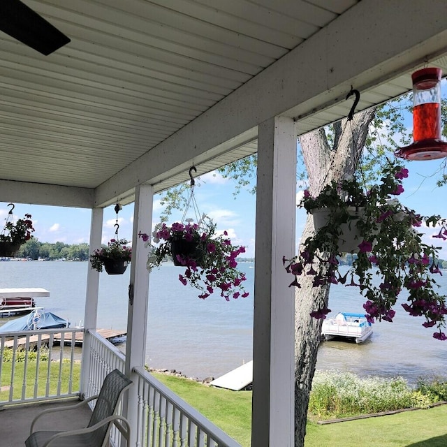wooden terrace featuring a water view