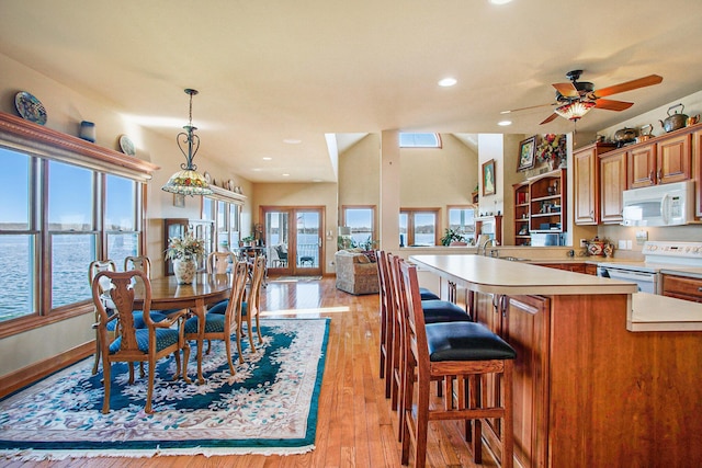 dining room featuring baseboards, light wood-type flooring, recessed lighting, and a ceiling fan