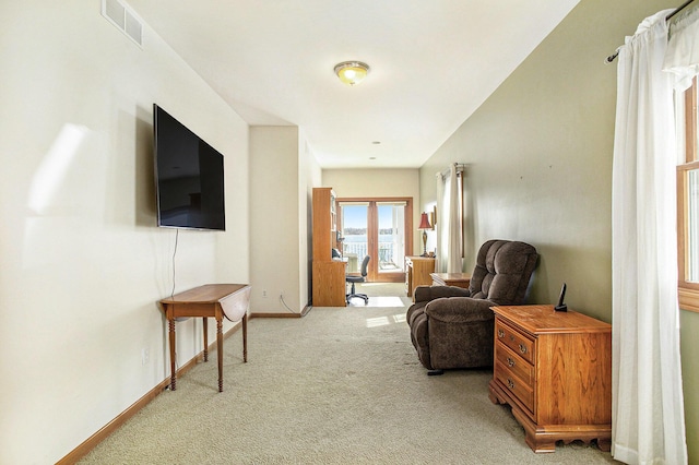 sitting room with french doors, carpet, baseboards, and visible vents
