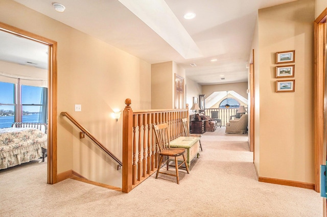 corridor featuring baseboards, an upstairs landing, recessed lighting, and carpet