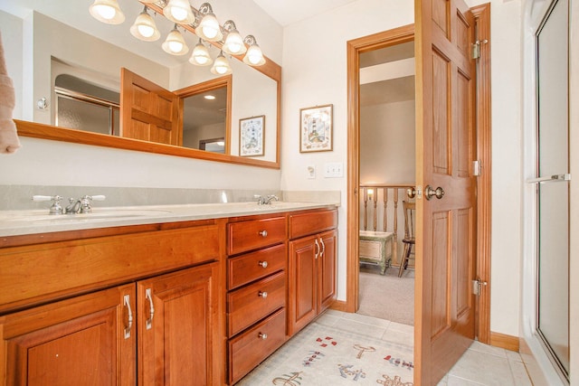 bathroom with a shower with door, tile patterned floors, double vanity, and a sink