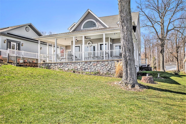 back of property featuring a porch and a yard