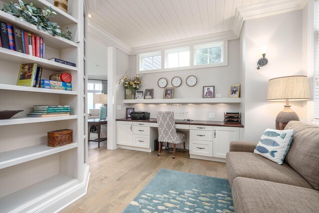 office area with wood ceiling, built in desk, ornamental molding, and light wood-type flooring