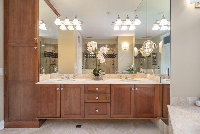 full bathroom featuring double vanity, tiled shower, and a sink