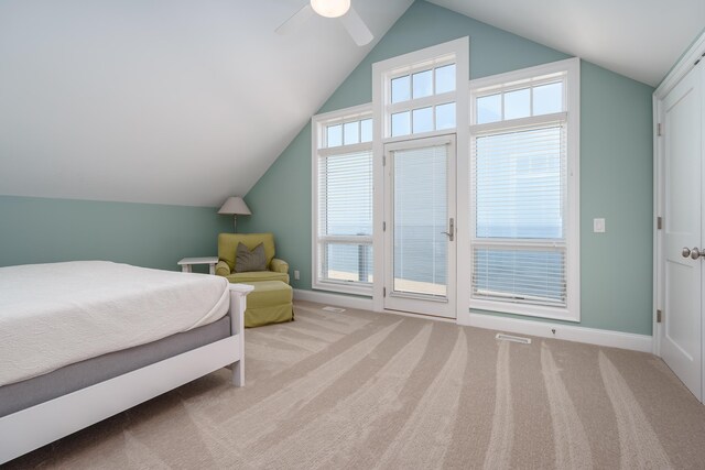 bedroom with carpet floors, baseboards, and lofted ceiling