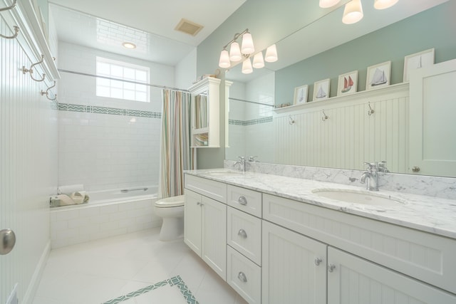 full bathroom with tiled shower / bath combo, tile patterned flooring, a sink, and visible vents