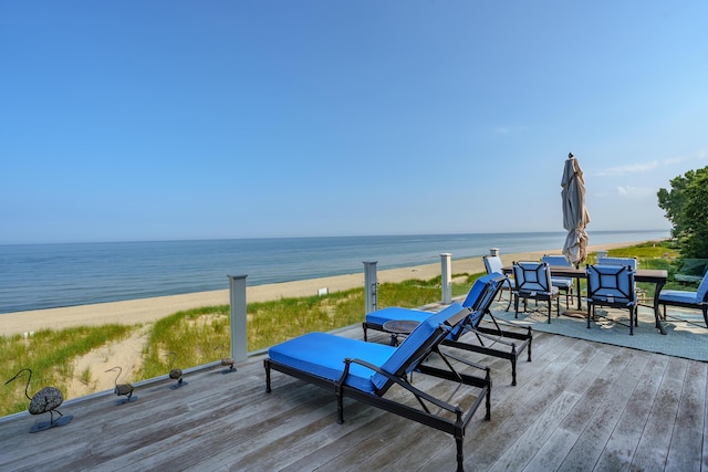 deck featuring a view of the beach and a water view