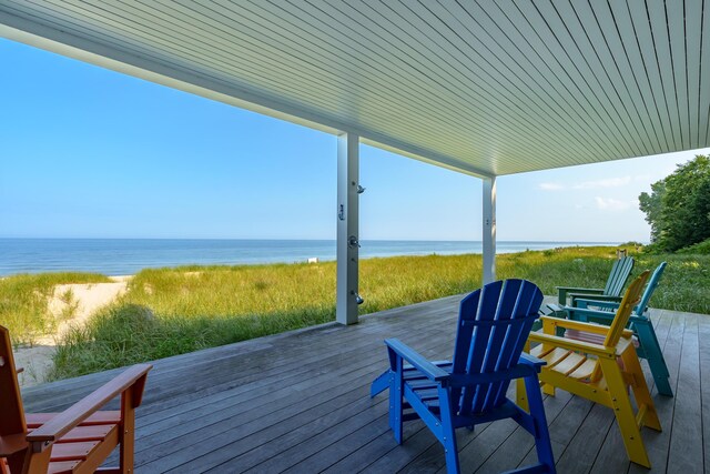 wooden terrace featuring a water view