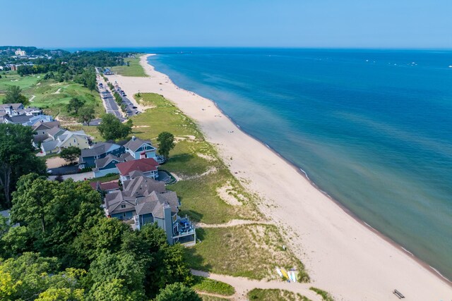 birds eye view of property featuring a beach view and a water view