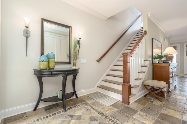 stairs with baseboards, stone tile flooring, and crown molding