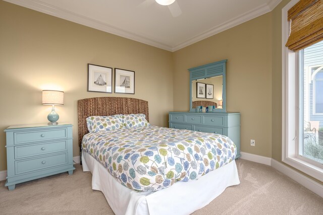 bedroom featuring light carpet, baseboards, ceiling fan, and ornamental molding