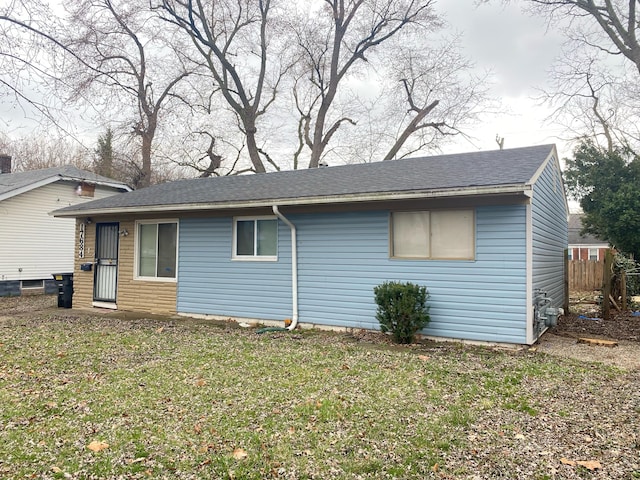 17684 Fenton St, Detroit, MI 48219 - exterior space with roof with shingles and a lawn