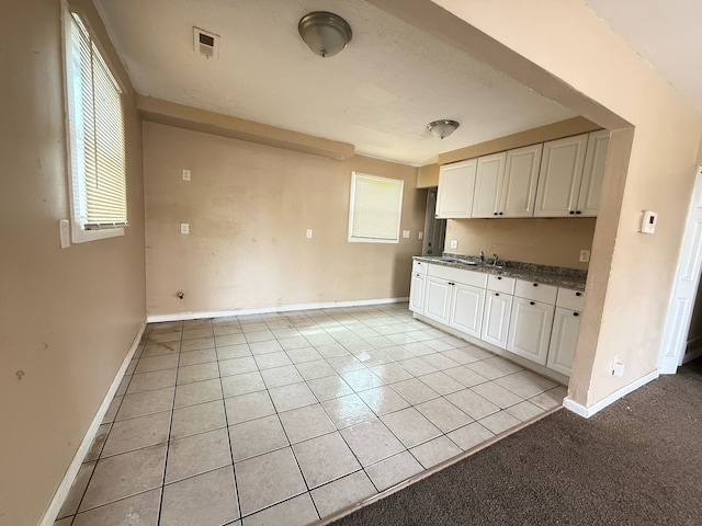 17684 Fenton St, Detroit, MI 48219 - kitchen featuring visible vents, white cabinetry, baseboards, and light tile patterned flooring