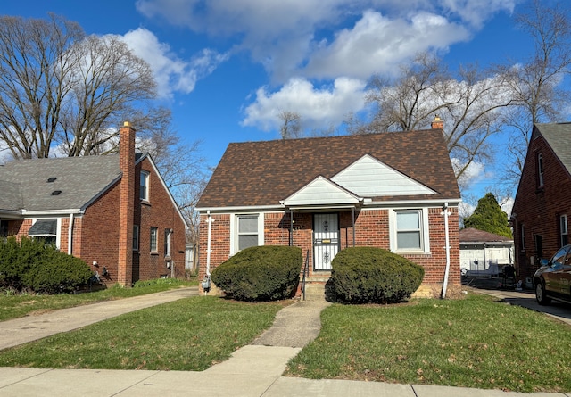18484 Ashton Ave, Detroit, MI 48219 - bungalow-style house with a front yard, a chimney, brick siding, and roof with shingles