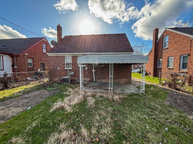 18484 Ashton Ave, Detroit, MI 48219 - back of property featuring a patio, a yard, a fenced backyard, and brick siding