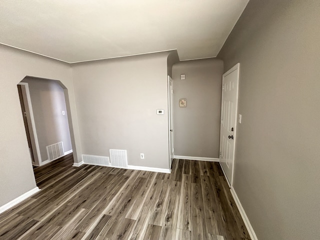 18484 Ashton Ave, Detroit, MI 48219 - spare room with visible vents, baseboards, arched walkways, and wood finished floors