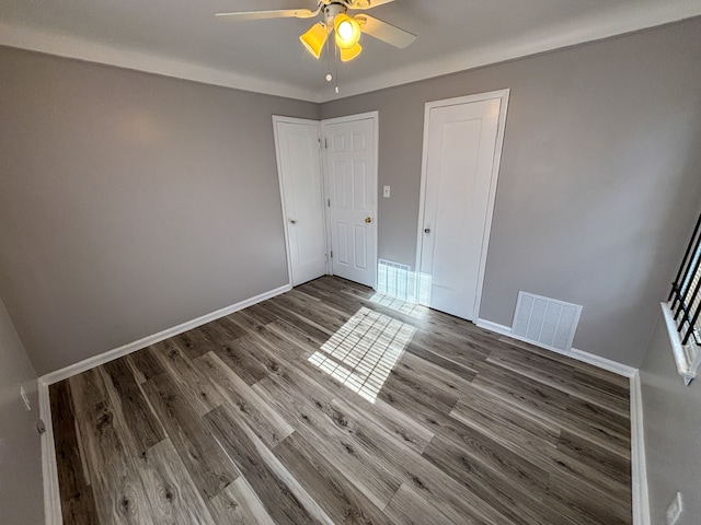 18484 Ashton Ave, Detroit, MI 48219 - unfurnished bedroom featuring visible vents, baseboards, ceiling fan, and wood finished floors