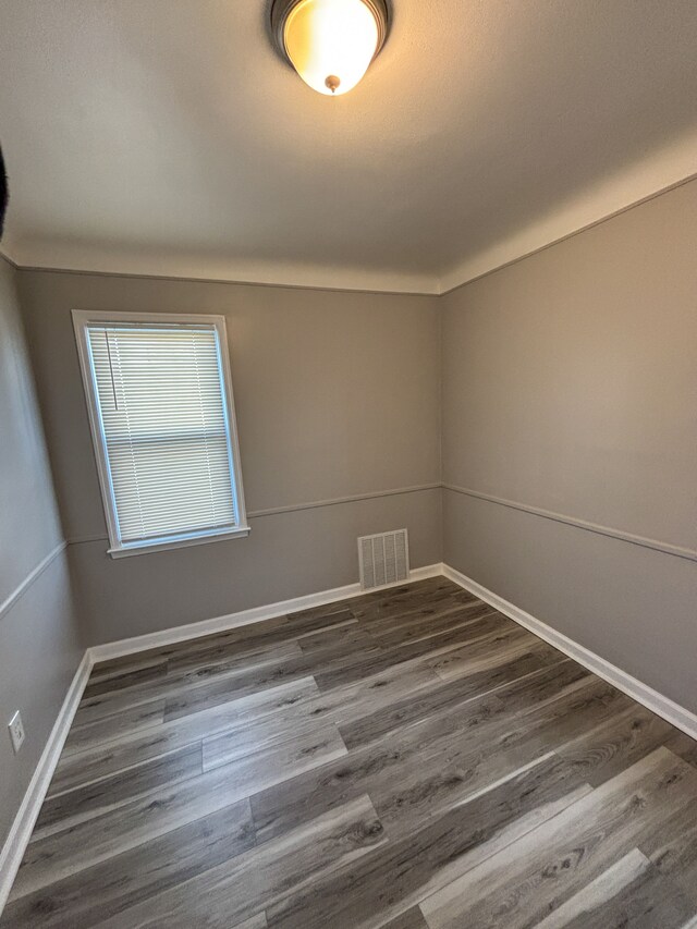 18484 Ashton Ave, Detroit, MI 48219 - spare room featuring dark wood-type flooring, visible vents, and baseboards