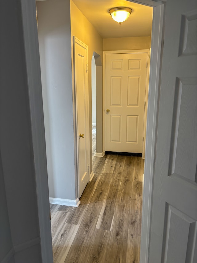 18484 Ashton Ave, Detroit, MI 48219 - hall featuring arched walkways, wood finished floors, and baseboards