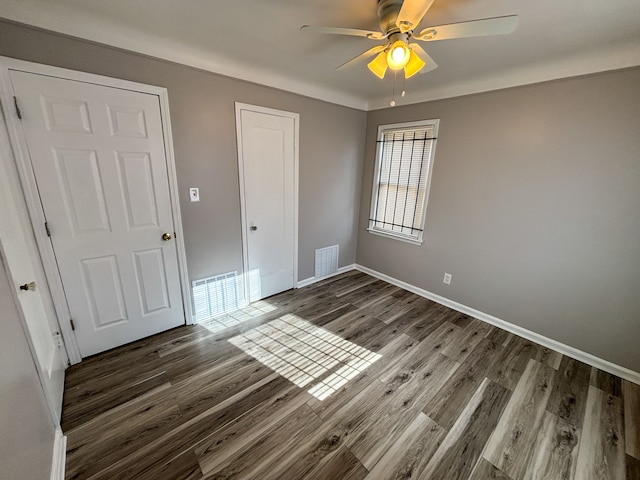 18484 Ashton Ave, Detroit, MI 48219 - unfurnished bedroom with a closet, baseboards, visible vents, ceiling fan, and wood finished floors