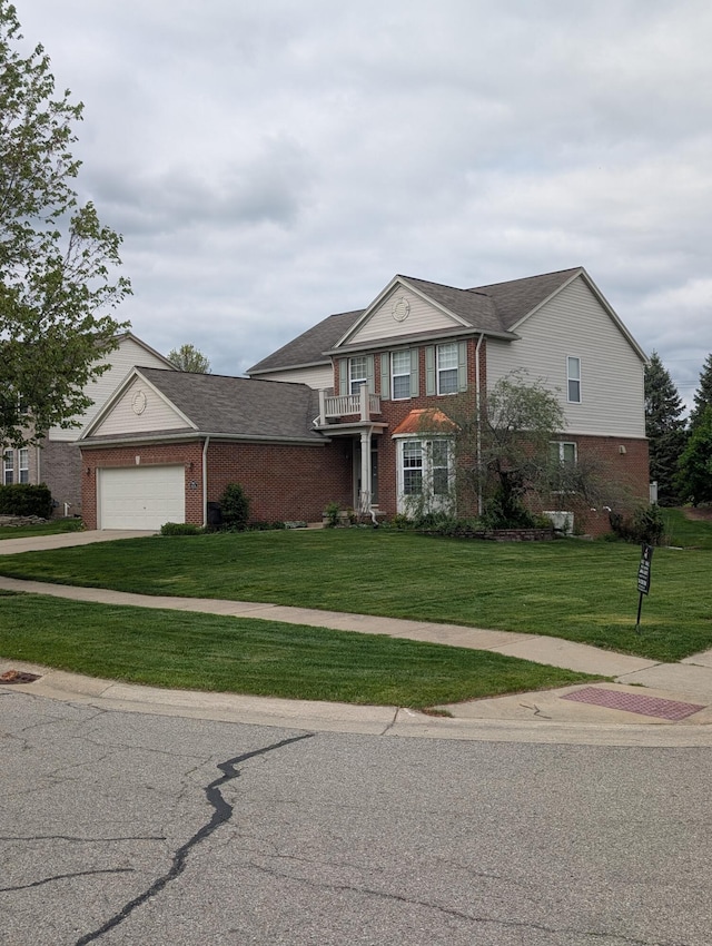 1960 Frances Way, Ypsilanti, MI 48198 - traditional-style house featuring brick siding, a balcony, a front lawn, an attached garage, and driveway