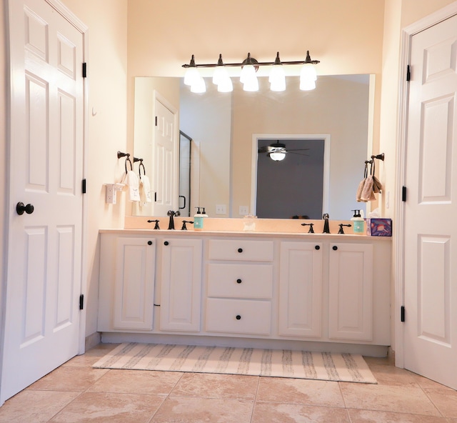 full bathroom featuring double vanity, ceiling fan, a sink, and tile patterned flooring
