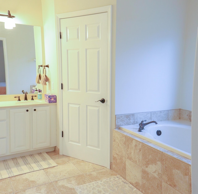 full bathroom featuring tile patterned flooring, vanity, and a garden tub