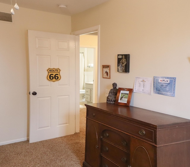 interior space with baseboards, carpet flooring, and visible vents