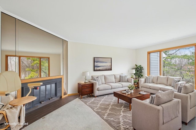 living area featuring wood finished floors and a healthy amount of sunlight