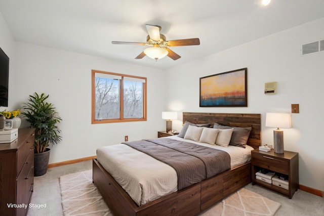 bedroom featuring visible vents, baseboards, ceiling fan, and light carpet