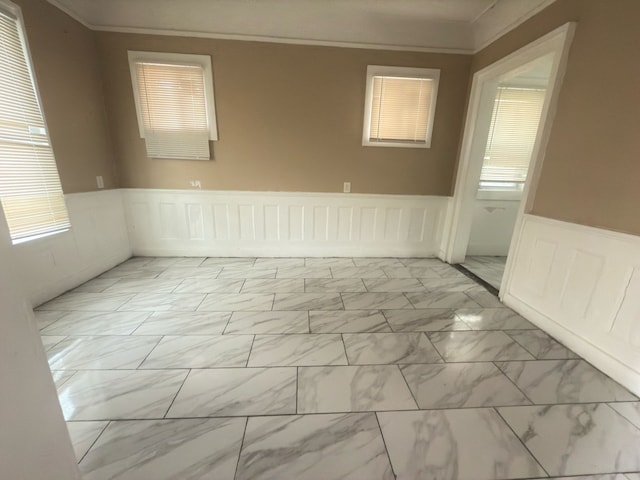 3297 Hazelwood St, Detroit, MI 48206 - empty room featuring crown molding, marble finish floor, wainscoting, and plenty of natural light