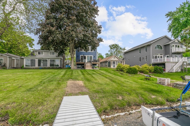 8841 Waruf Ave, Portage, MI 49002 - view of green lawn featuring stairs and a wooden deck