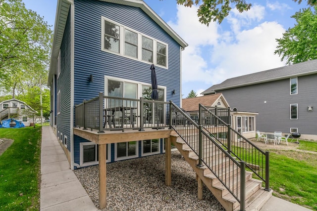 8841 Waruf Ave, Portage, MI 49002 - rear view of property featuring a deck, stairs, and a lawn