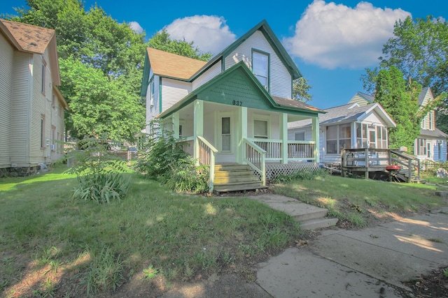 637 Prospect Ave NE, Grand Rapids, MI 49503 - view of front of home with covered porch, a front yard, a sunroom, and roof with shingles