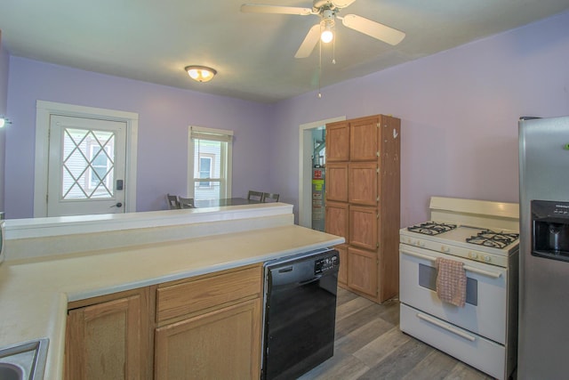 637 Prospect Ave NE, Grand Rapids, MI 49503 - kitchen with white range with gas cooktop, black dishwasher, stainless steel fridge with ice dispenser, light wood-type flooring, and light countertops
