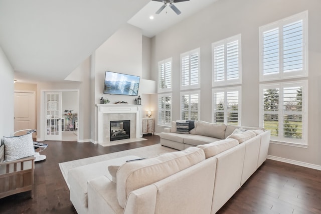 7416 Secretariat Dr, Saline, MI 48176 - living room featuring ceiling fan, a towering ceiling, baseboards, and a wealth of natural light
