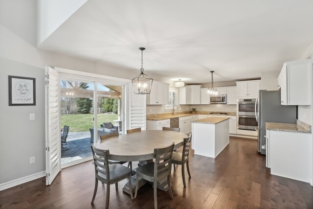 7416 Secretariat Dr, Saline, MI 48176 - dining area featuring an inviting chandelier, baseboards, and dark wood-style floors