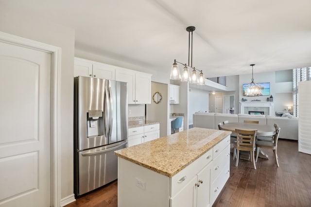 7416 Secretariat Dr, Saline, MI 48176 - kitchen with stainless steel fridge with ice dispenser, open floor plan, dark wood-style floors, and a kitchen island