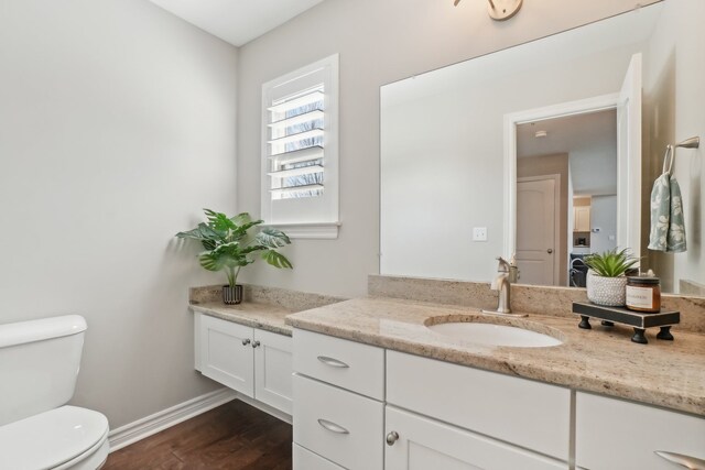 7416 Secretariat Dr, Saline, MI 48176 - bathroom featuring toilet, vanity, wood finished floors, and baseboards