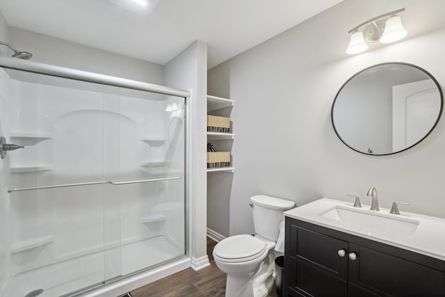 7416 Secretariat Dr, Saline, MI 48176 - bathroom featuring vanity, baseboards, a stall shower, toilet, and wood finished floors