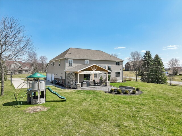 7416 Secretariat Dr, Saline, MI 48176 - rear view of house with a yard, a playground, a patio, and roof with shingles