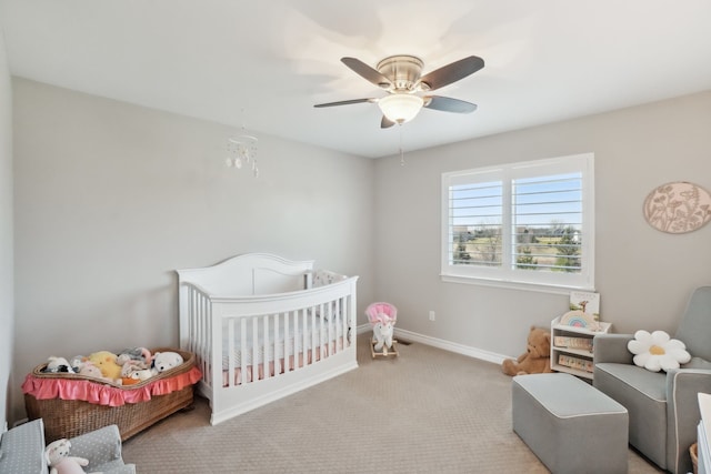 7416 Secretariat Dr, Saline, MI 48176 - carpeted bedroom featuring a crib, baseboards, and a ceiling fan