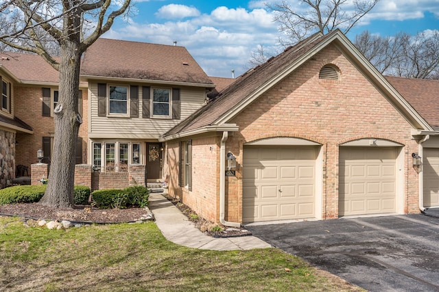 view of front of home with an attached garage, a shingled roof, aphalt driveway, and brick siding