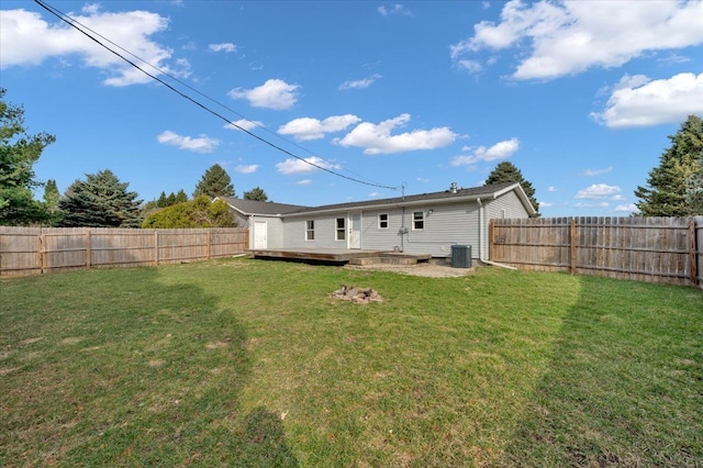 back of house featuring a fenced backyard, a lawn, and a deck